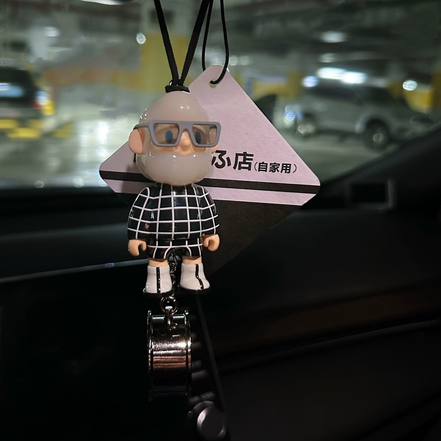 UrbanPop dashboard charm figure with pink hair, hoodie, and sneaker keychain hanging on rearview mirror – collectible streetwear vibe
