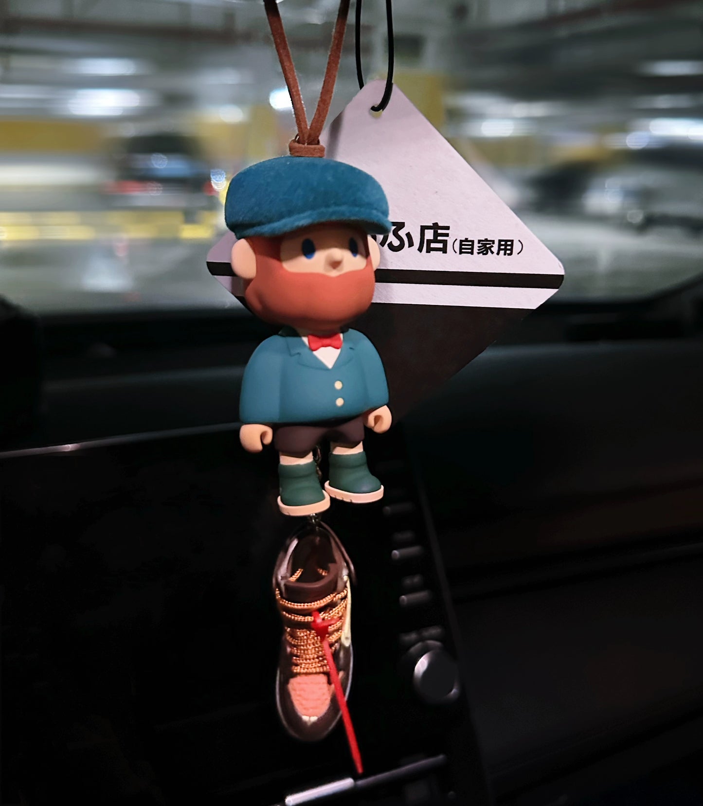 UrbanPop dashboard charm figure with pink hair, hoodie, and sneaker keychain hanging on rearview mirror – collectible streetwear vibe
