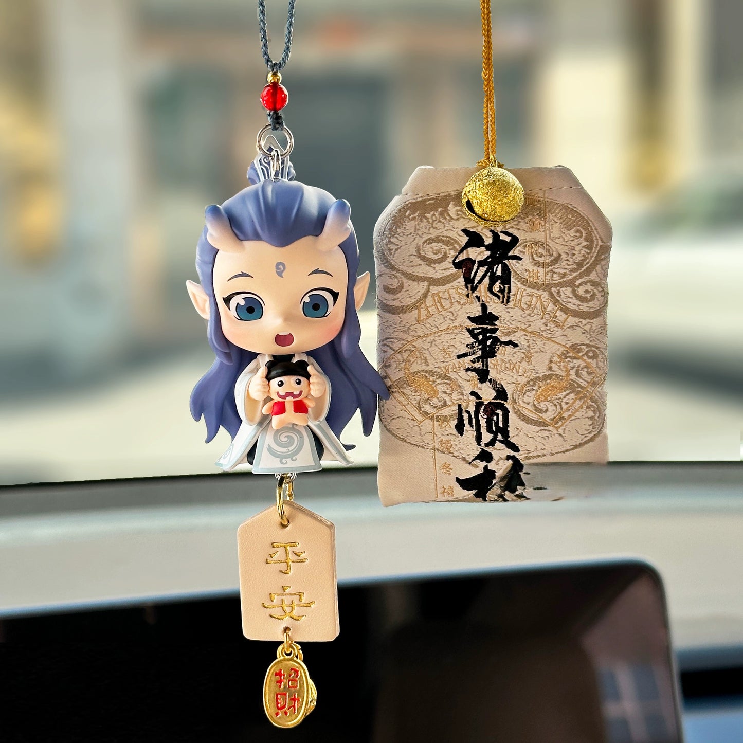 nezha inspired rear view mirror car charm with red ribbons and lucky amulet hanging