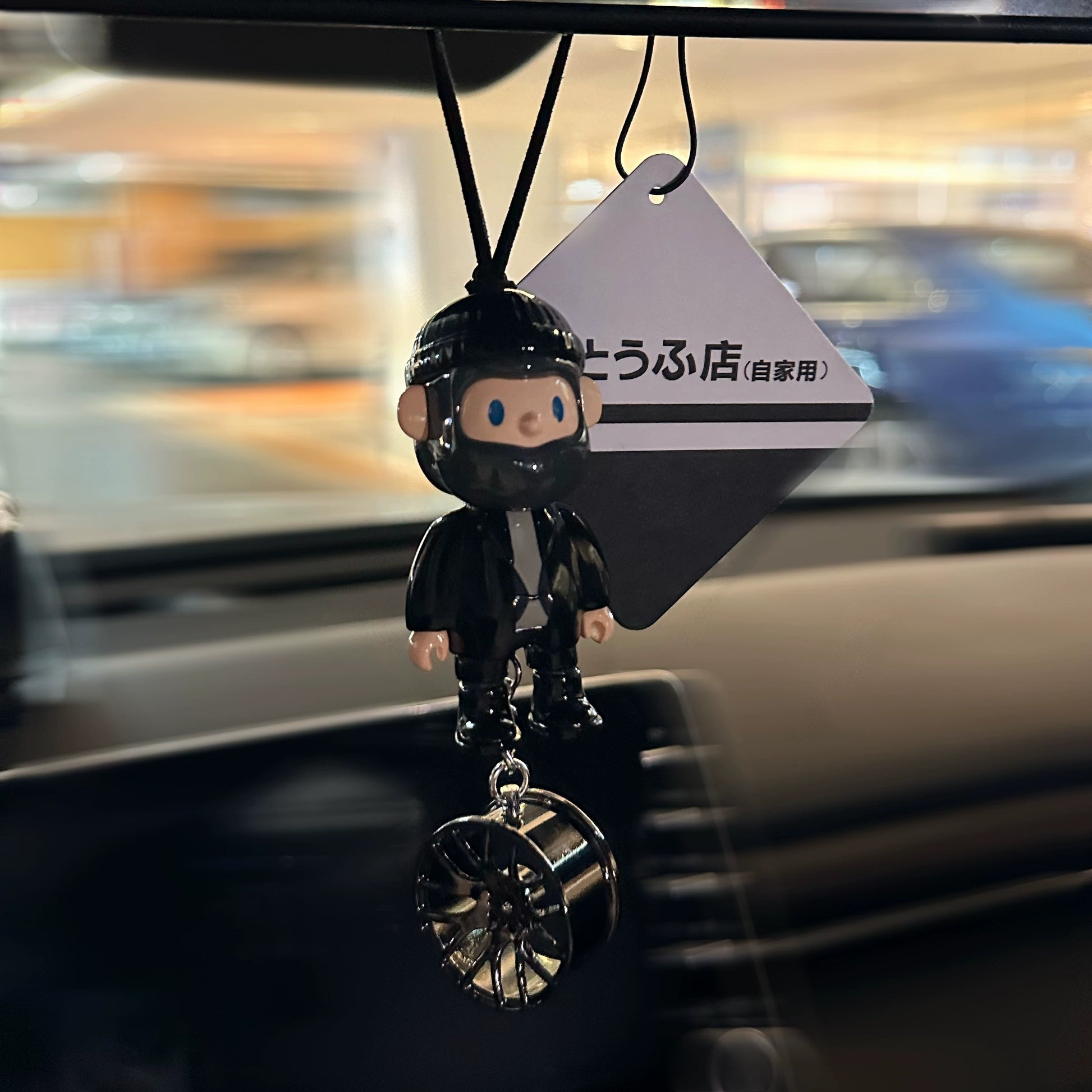 UrbanPop dashboard charm figure with pink hair, hoodie, and sneaker keychain hanging on rearview mirror – collectible streetwear vibe