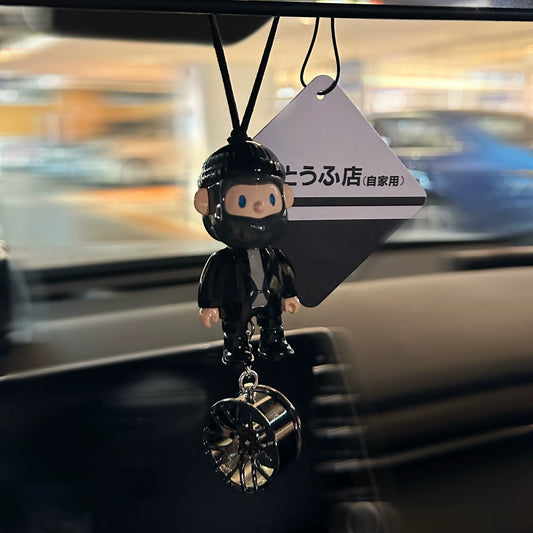 UrbanPop dashboard charm figure with pink hair, hoodie, and sneaker keychain hanging on rearview mirror – collectible streetwear vibe