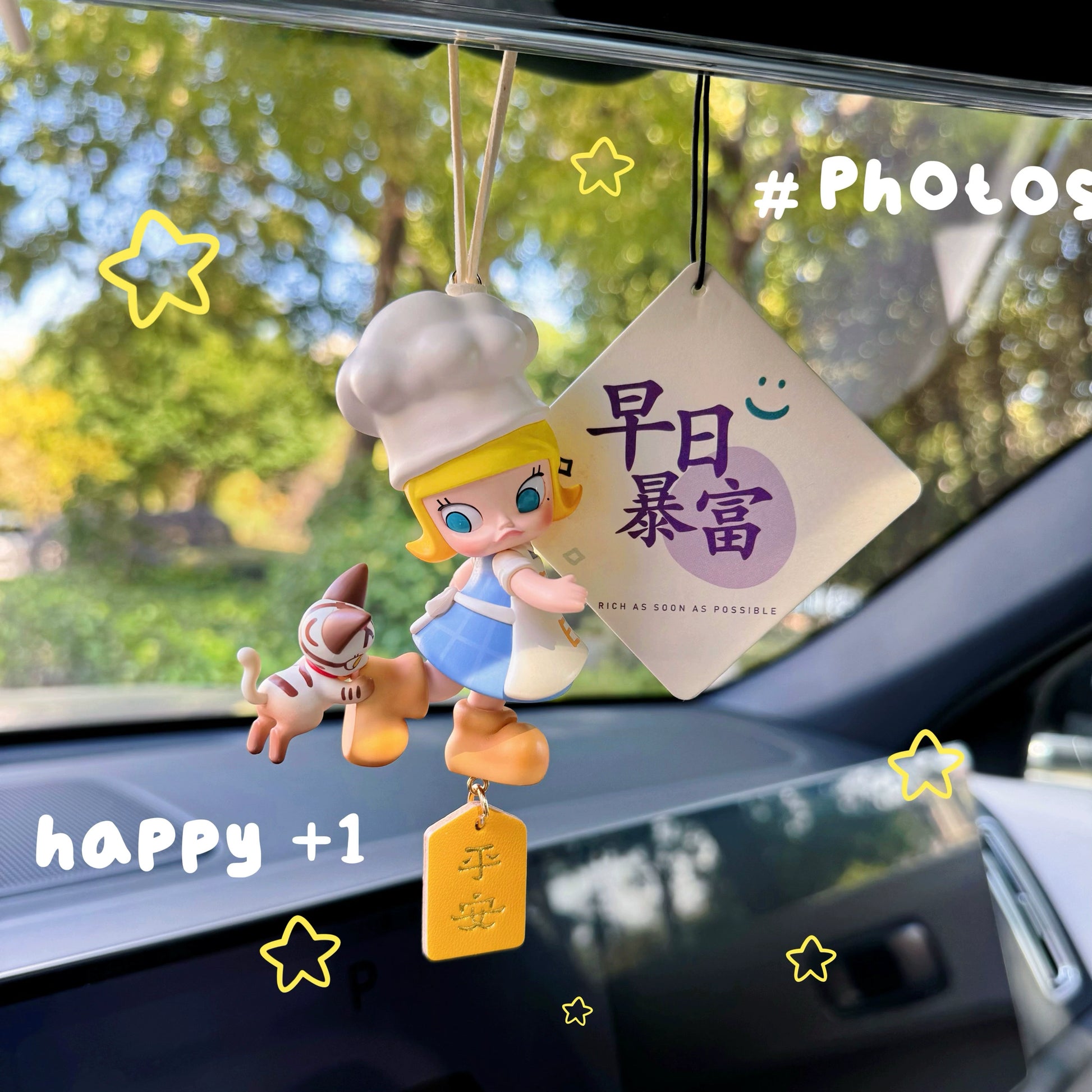 Luvbubu SweetDrive Girl dashboard doll in pink dress with good luck charm tag hanging in car interior