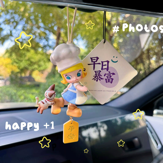 Luvbubu SweetDrive Girl dashboard doll in pink dress with good luck charm tag hanging in car interior