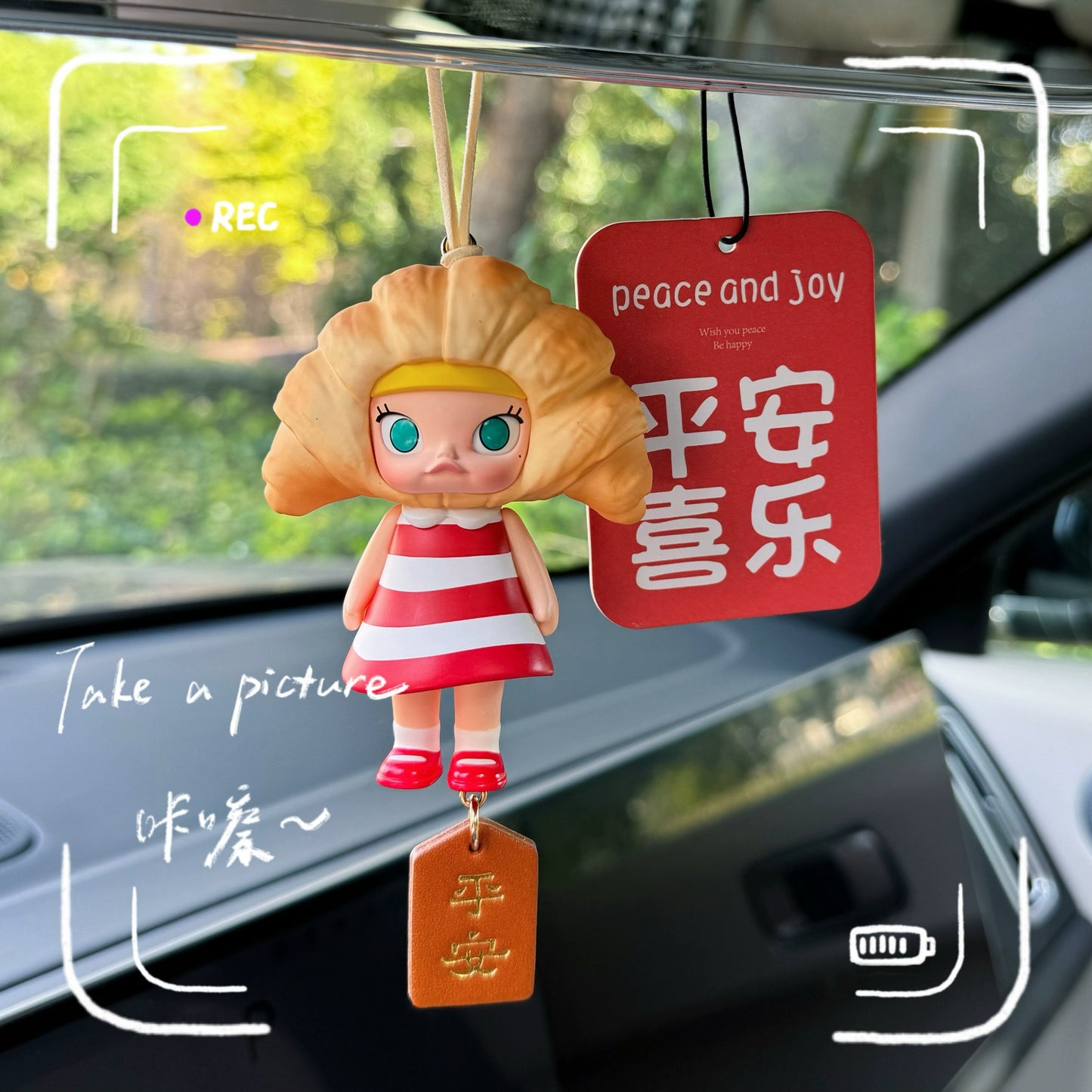 Luvbubu SweetDrive Girl dashboard doll in pink dress with good luck charm tag hanging in car interior