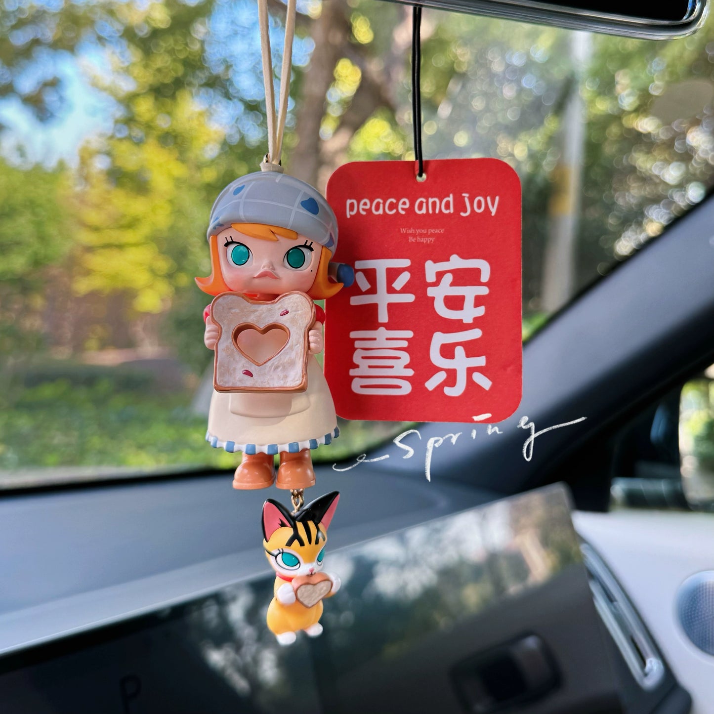 Luvbubu SweetDrive Girl dashboard doll in pink dress with good luck charm tag hanging in car interior